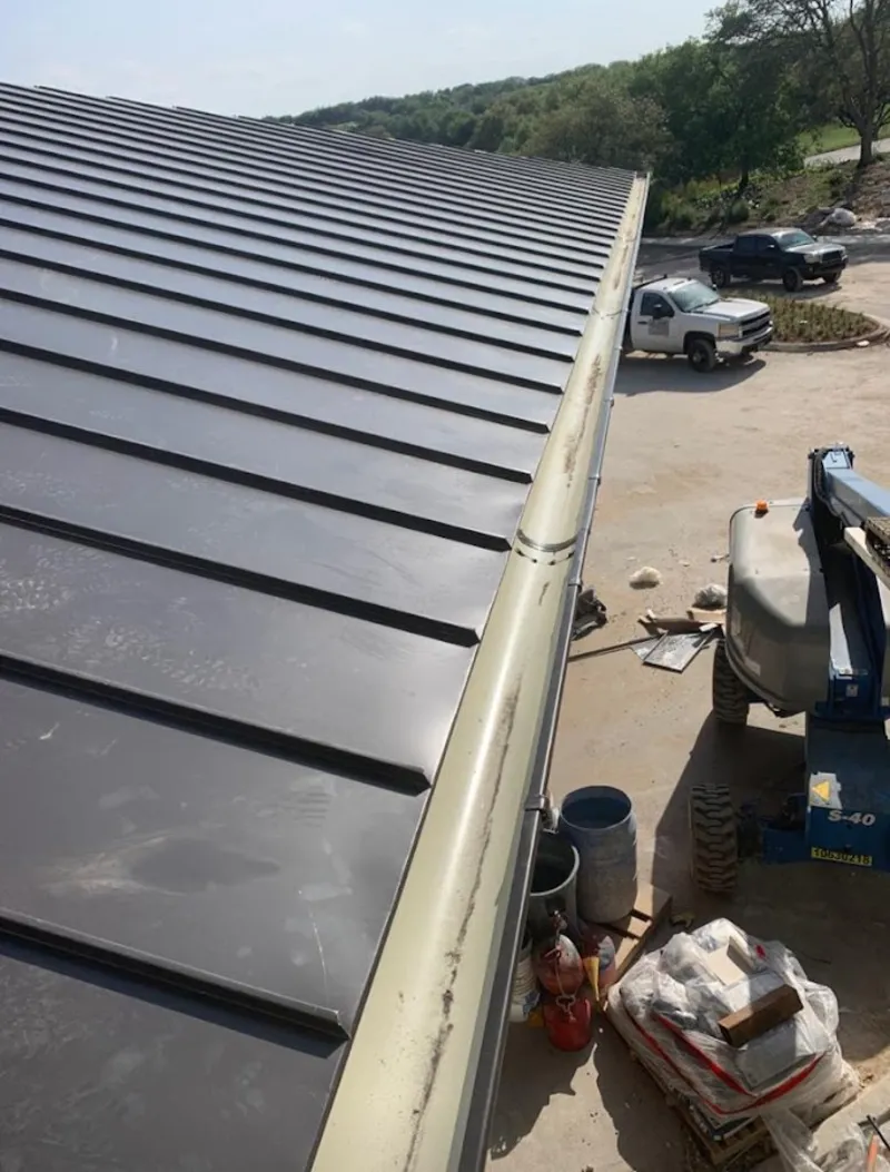 Standing seam panel and gutter detail on a metal roofing jobsite in Thonotosassa